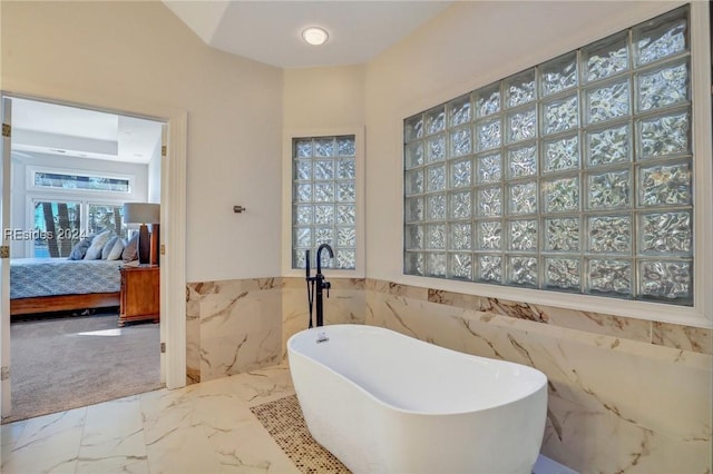 bathroom with tile walls and a washtub