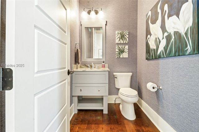 bathroom featuring vanity, toilet, and hardwood / wood-style floors