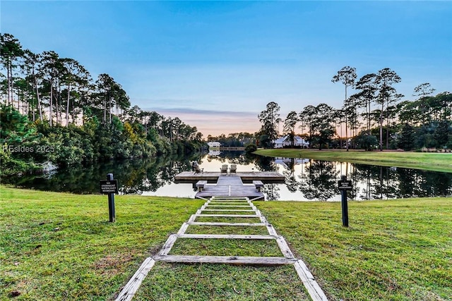 view of property's community with a lawn, a boat dock, and a water view