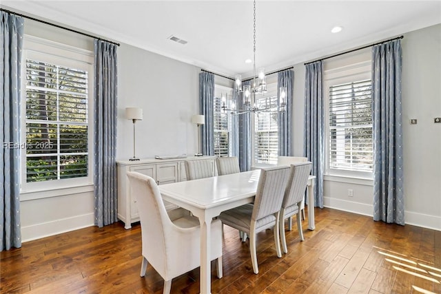 dining area featuring an inviting chandelier and dark hardwood / wood-style floors