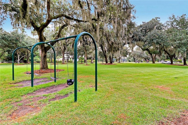 view of property's community featuring a yard and a playground