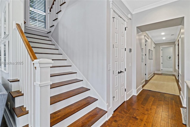 stairway featuring hardwood / wood-style flooring and ornamental molding