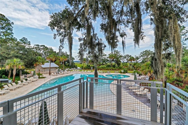 view of swimming pool with a patio area and a hot tub