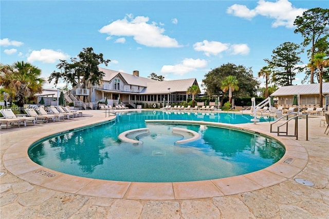 view of swimming pool with a patio area