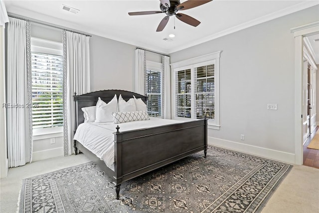 carpeted bedroom with crown molding and ceiling fan