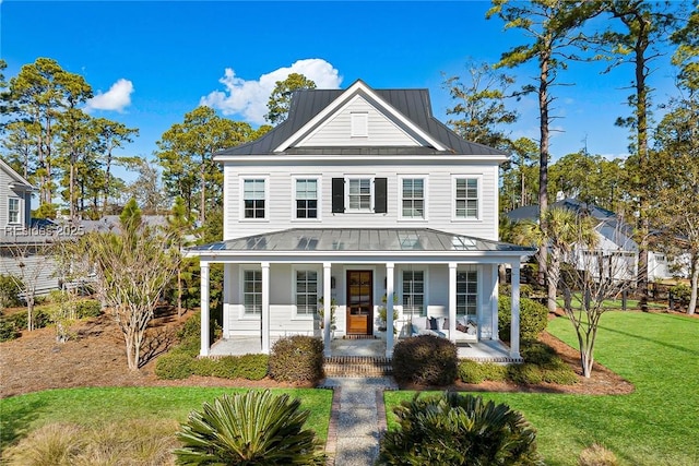 view of front of house featuring covered porch and a front lawn