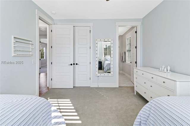 carpeted bedroom with connected bathroom and a closet