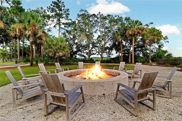 view of community featuring a patio and an outdoor fire pit