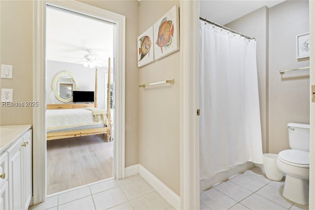 bathroom featuring ceiling fan, tile patterned floors, toilet, and vanity