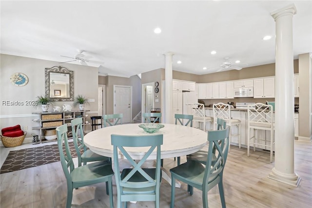 dining room featuring ceiling fan, decorative columns, and light hardwood / wood-style flooring