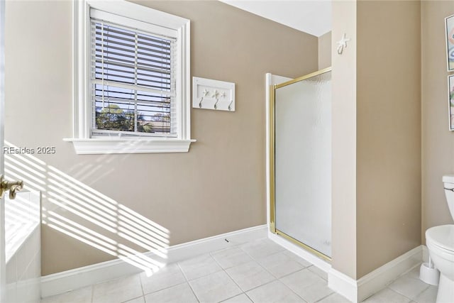 bathroom featuring tile patterned flooring, a shower with shower door, and toilet