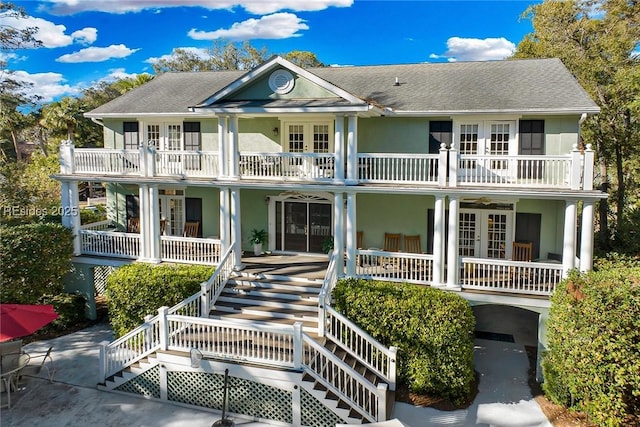 view of front of home featuring french doors and a balcony