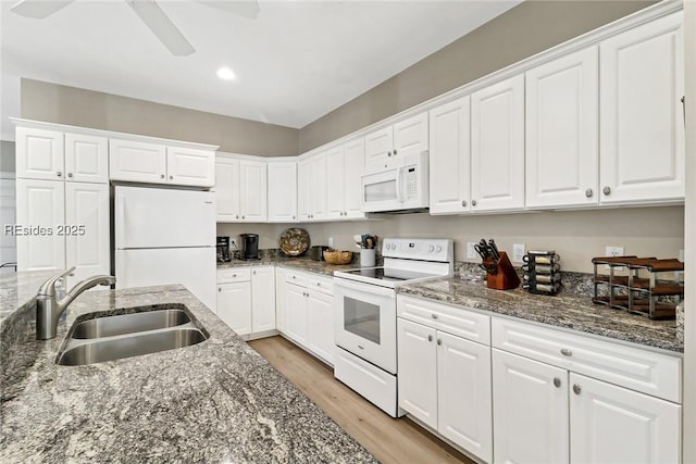 kitchen featuring white cabinetry, sink, white appliances, and light wood-type flooring