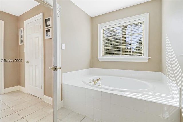 bathroom with tiled tub and tile patterned floors