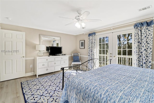 bedroom featuring access to outside, light hardwood / wood-style floors, french doors, and ceiling fan