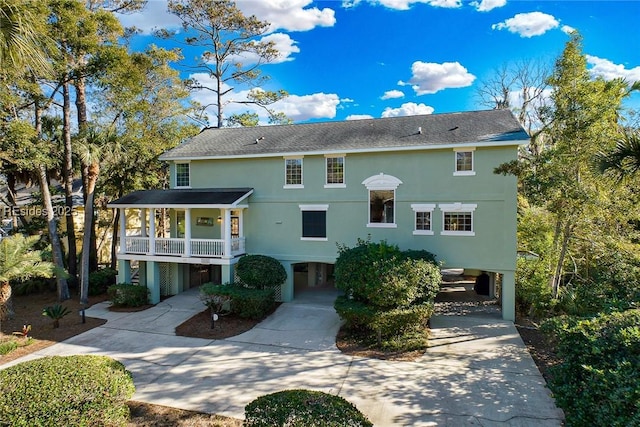 rear view of property with a carport and a porch