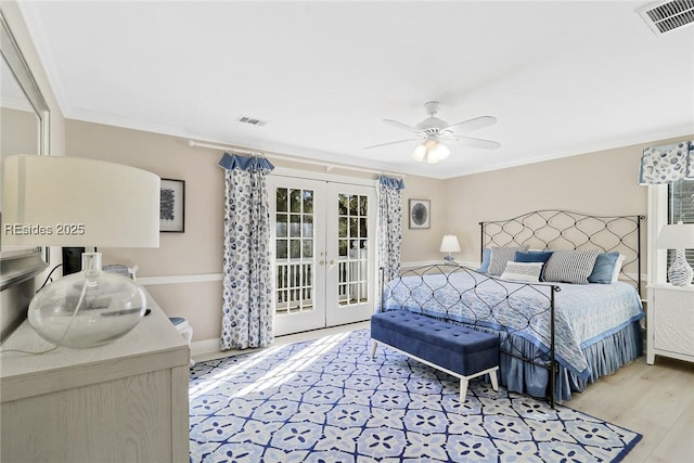 bedroom featuring ceiling fan, access to exterior, ornamental molding, light hardwood / wood-style floors, and french doors