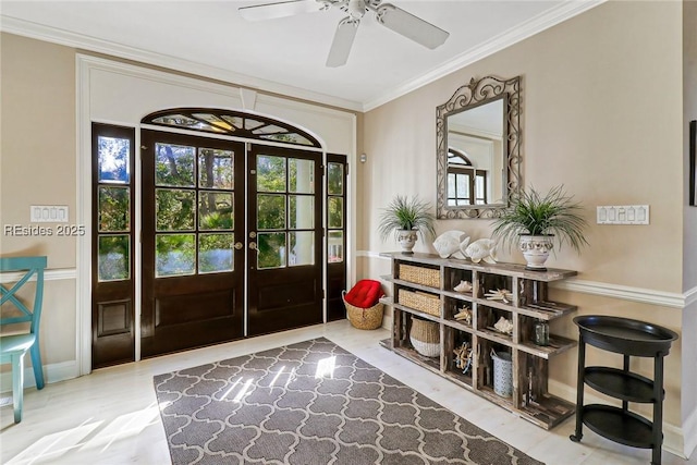 doorway with a wealth of natural light, ornamental molding, french doors, and ceiling fan