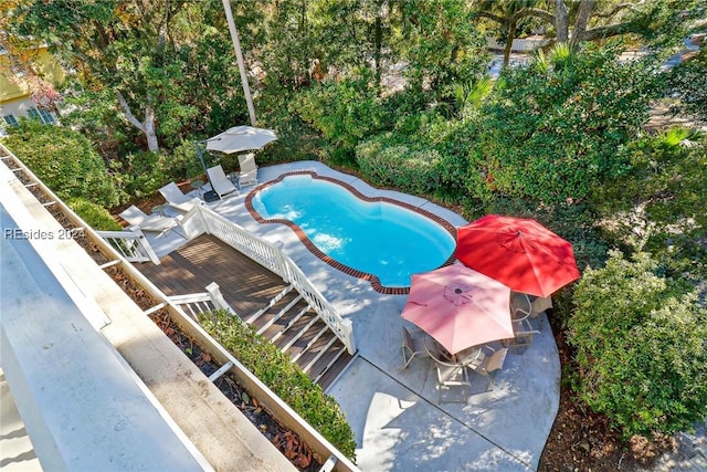 view of pool featuring a deck and a patio