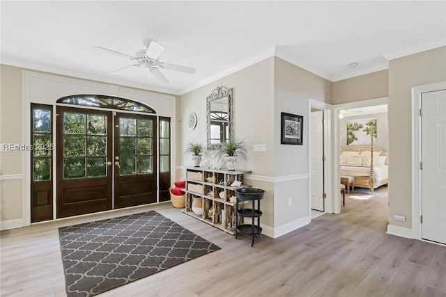 entryway featuring french doors, ceiling fan, ornamental molding, and light hardwood / wood-style floors