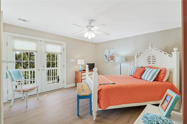 bedroom featuring access to exterior, wood-type flooring, french doors, and ceiling fan