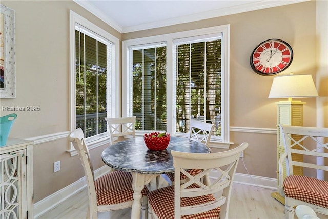 dining area featuring crown molding and light hardwood / wood-style flooring