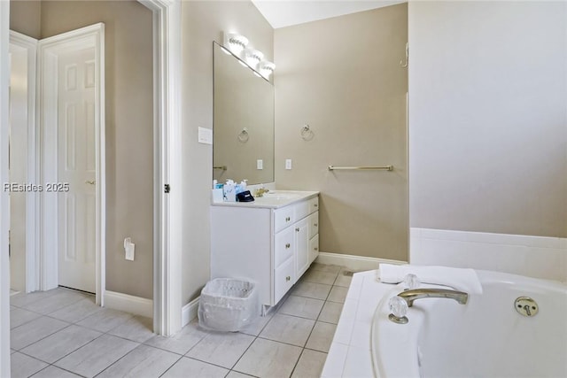 bathroom featuring vanity, a bath, and tile patterned floors