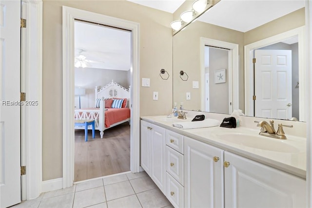 bathroom with tile patterned flooring, vanity, and ceiling fan