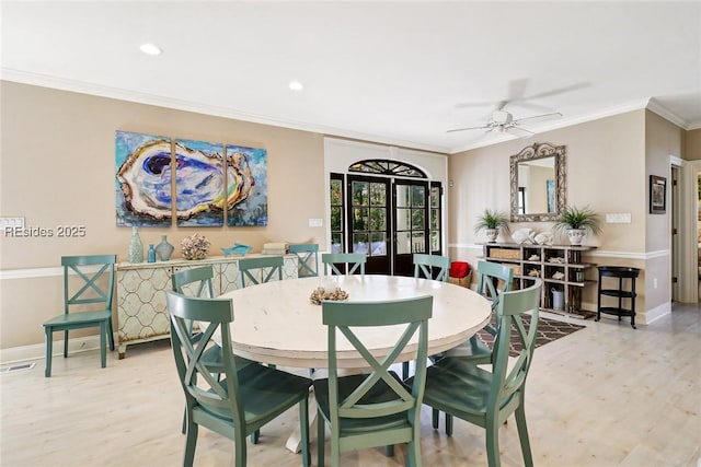 dining room featuring ceiling fan, ornamental molding, and light hardwood / wood-style flooring