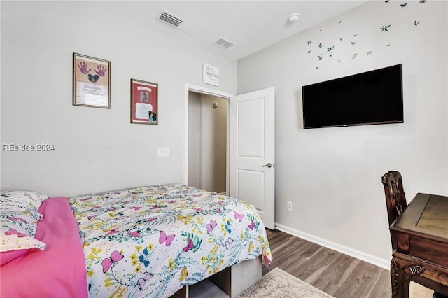 bedroom with hardwood / wood-style floors