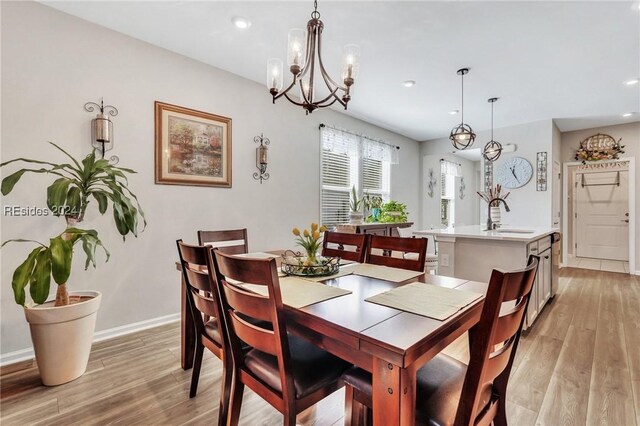 dining space featuring sink and light hardwood / wood-style floors