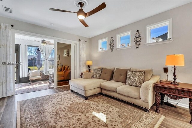 living room with hardwood / wood-style flooring and ceiling fan