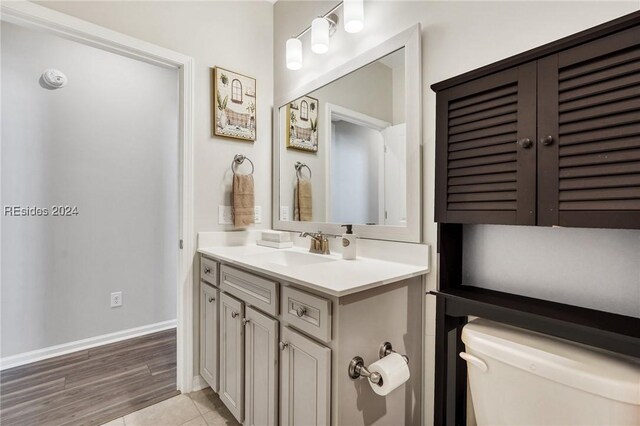 bathroom with vanity, tile patterned flooring, and toilet