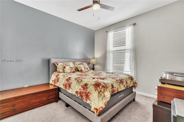 carpeted bedroom with ceiling fan