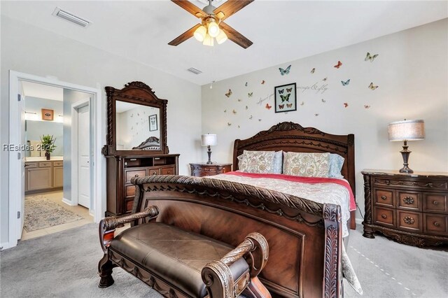 carpeted bedroom with ceiling fan and connected bathroom