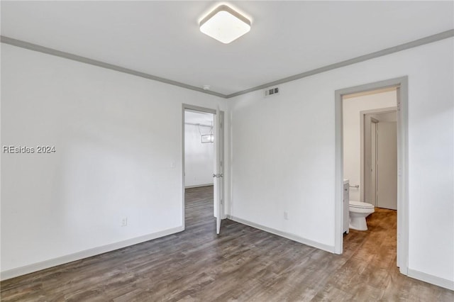 spare room with crown molding and hardwood / wood-style floors