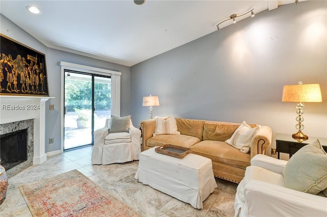 living room featuring a high end fireplace and rail lighting