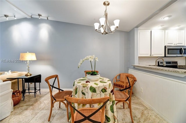 dining area with an inviting chandelier