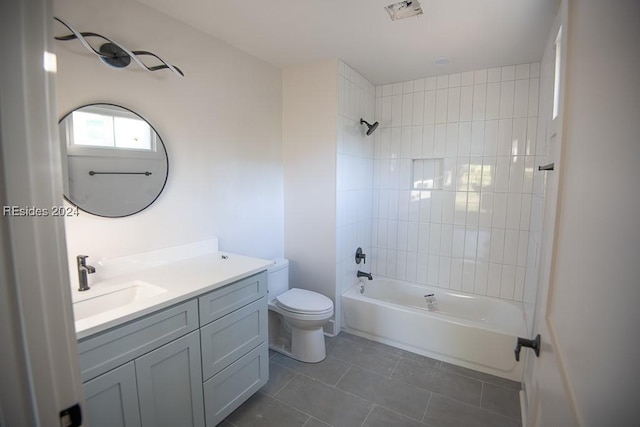 full bathroom with tiled shower / bath combo, vanity, tile patterned floors, and toilet