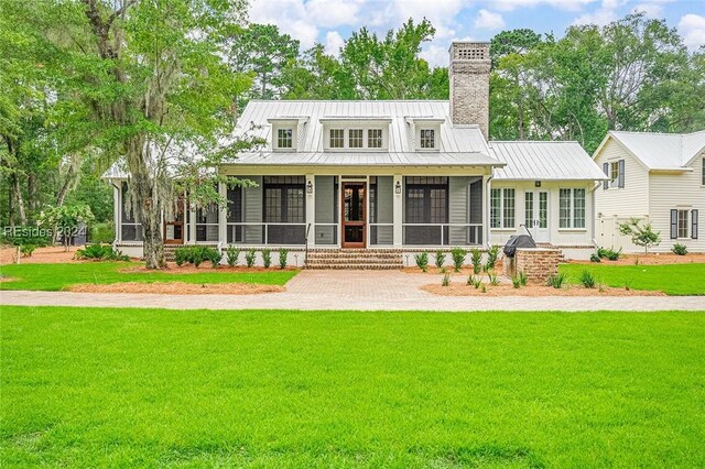 view of front of property with a front lawn and a sunroom