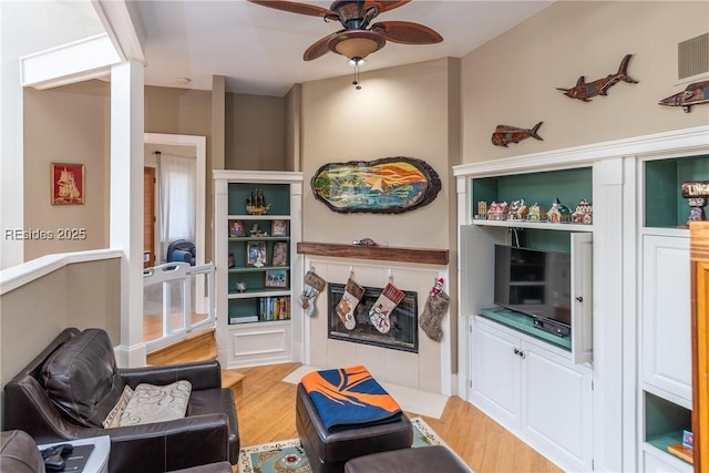 sitting room featuring hardwood / wood-style flooring and ceiling fan