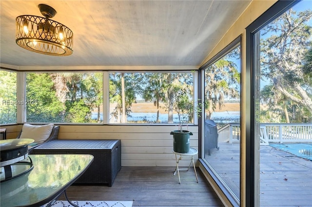 sunroom with a chandelier