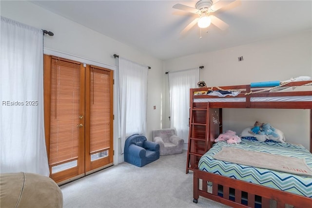 carpeted bedroom featuring french doors and ceiling fan