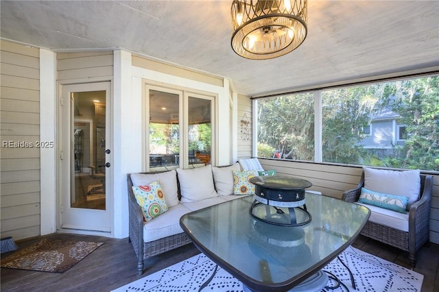 sunroom with a notable chandelier