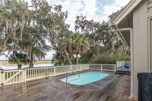 view of swimming pool featuring a deck with water view