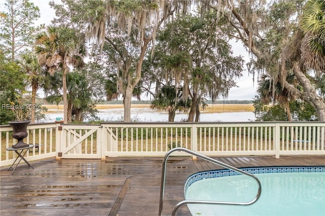 wooden terrace featuring a water view