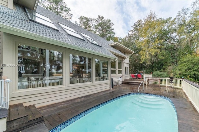 view of swimming pool with a deck