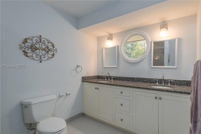 bathroom with tile patterned flooring, vanity, and toilet