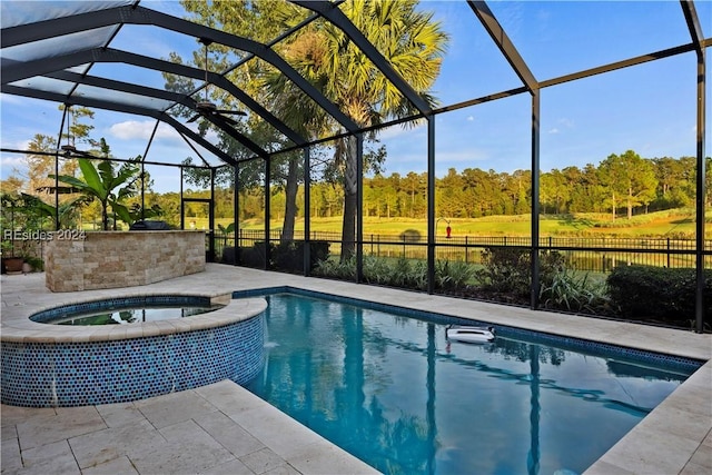 view of swimming pool featuring an in ground hot tub, a patio, and glass enclosure