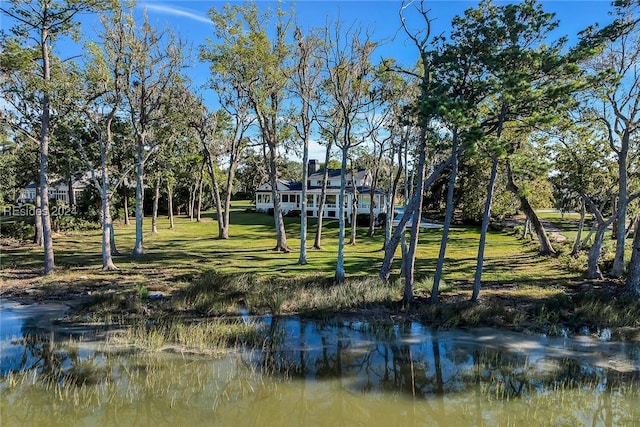 view of community with a water view and a yard